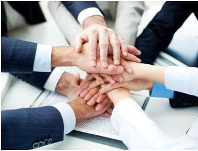 Hands joined together representing community work